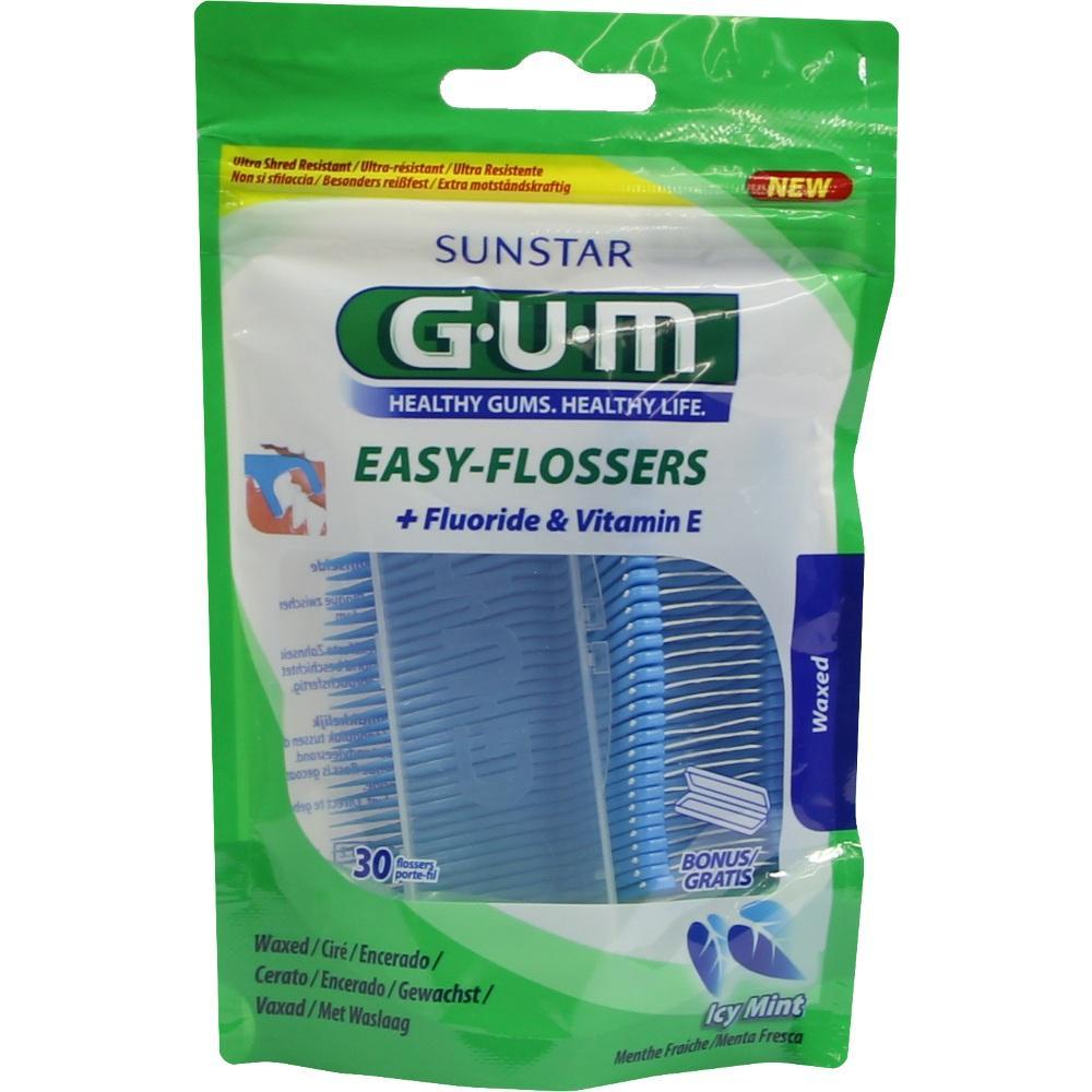 Eine Packung Zahnseide-Sticks mit Fluorid und Vitamin E in grünem Beutel.